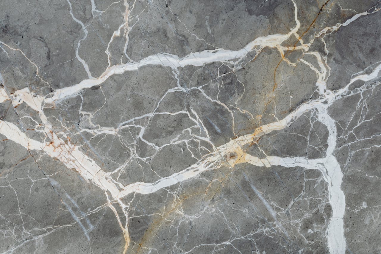 Detailed close-up of natural marble surface showcasing intricate vein patterns for design projects.